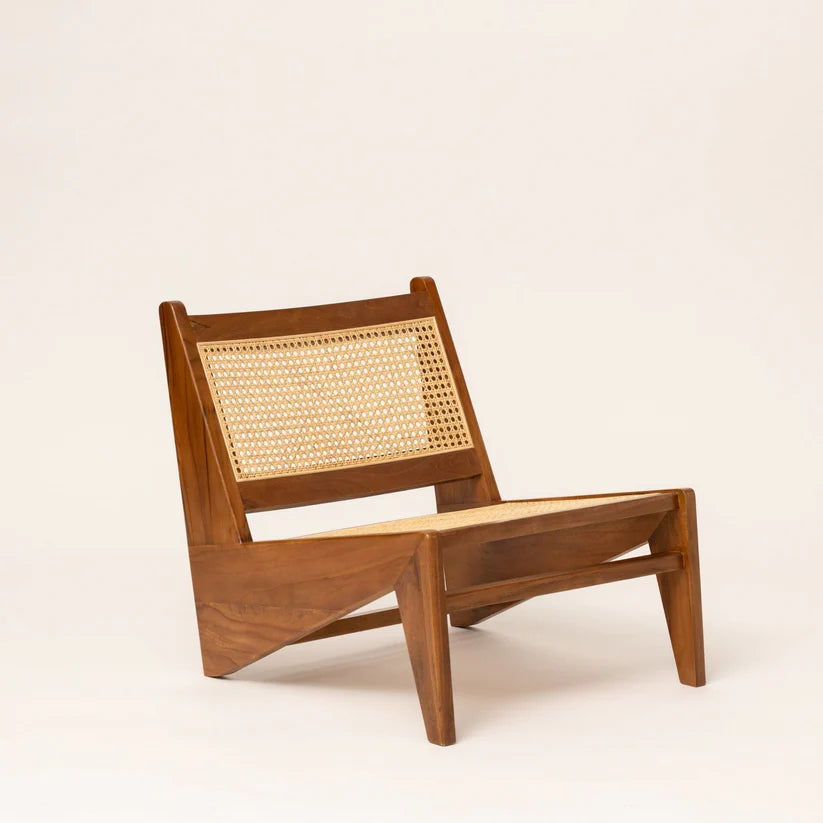 Wooden lounge chair with wicker backrest on a beige background